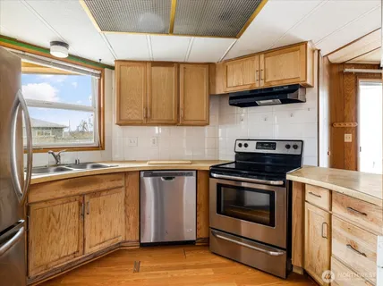 a kitchen with stainless steel appliances granite countertop a stove and a sink