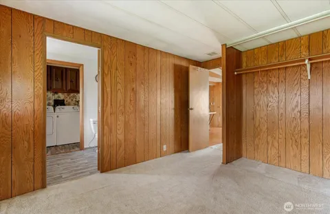 a view of a room with an empty space and a bathroom