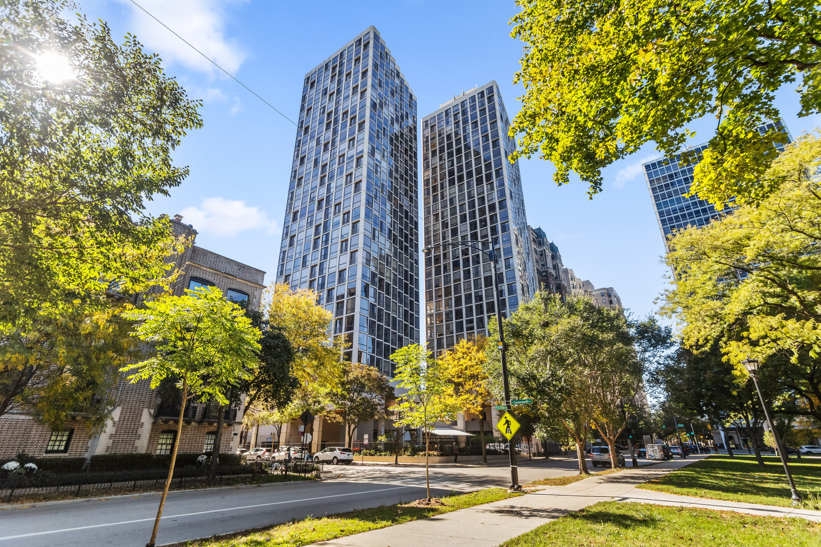 a view of a tall building next to a road