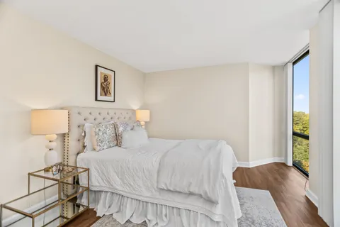 a bedroom with a bed and a night stand