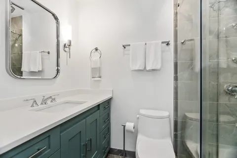a bathroom with a sink toilet and shower