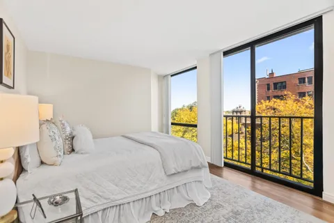 a bedroom with a bed and painting on the wall