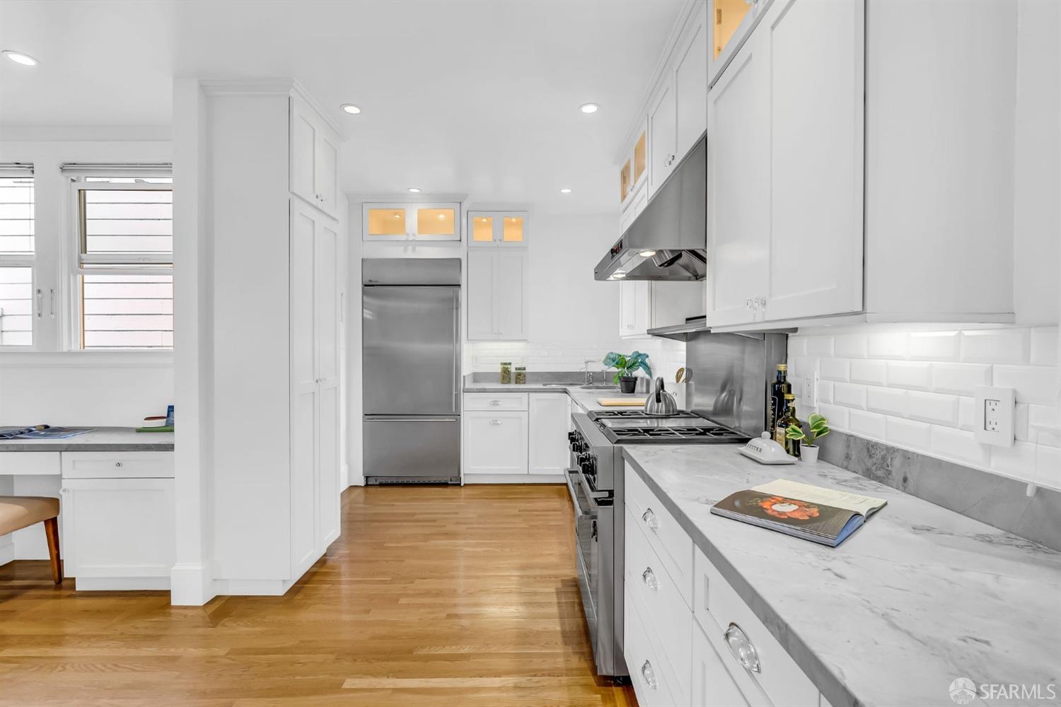 1049 Clay Street San Francisco, CA 94108 - Photo 13 of 28 a kitchen with a stove a sink and a refrigerator