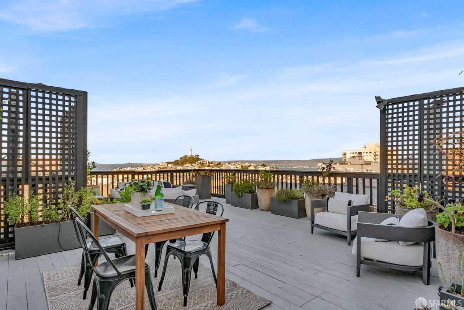 1049 Clay Street San Francisco, CA 94108 - Photo 2 of 28 a balcony with wooden floor table and chairs