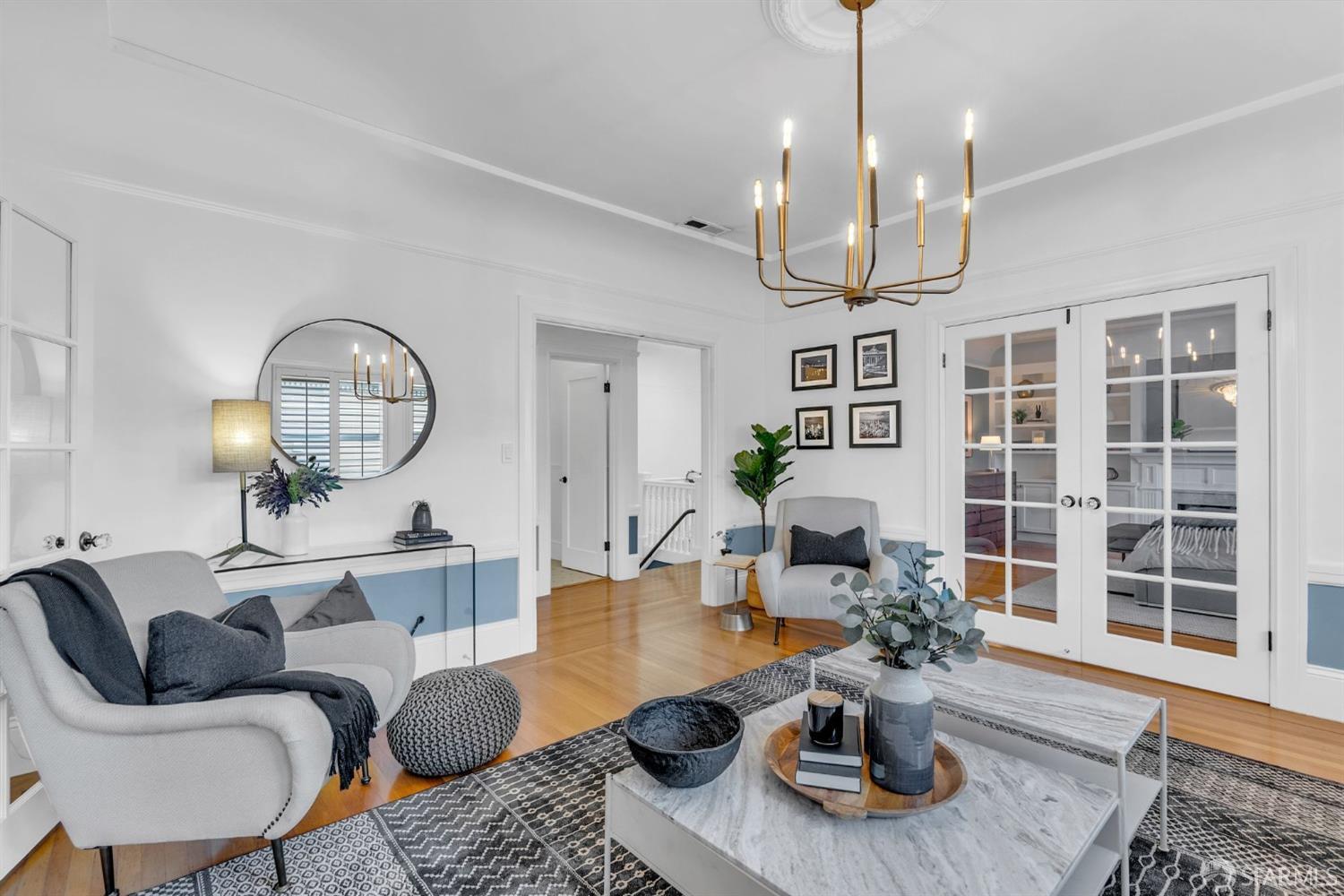 1049 Clay Street San Francisco, CA 94108 - Photo 4 of 28 a living room with furniture chandelier and a view of kitchen