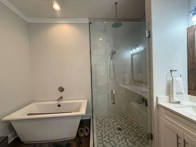 a bathroom with a bathtub and shower