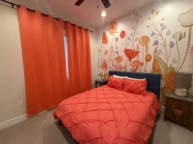 a bedroom with a bed and curtain