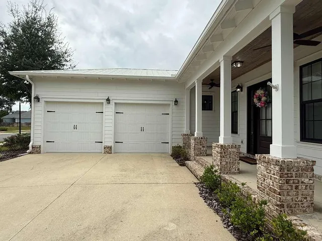a view of a house with potted plants