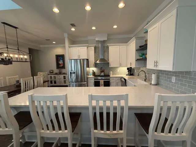 a large kitchen with lots of counter space and stainless steel appliances