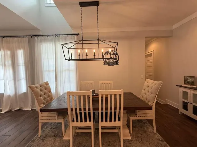 a view of a dining room with furniture wooden floor and chandelier