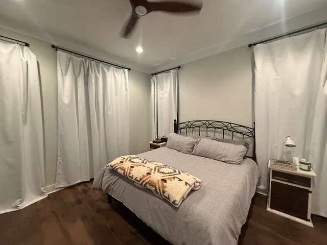 a bedroom with a large bed and a window