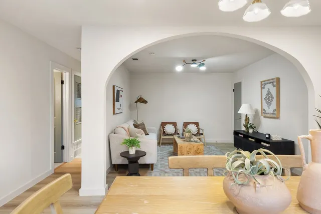 a living room with furniture and a chandelier