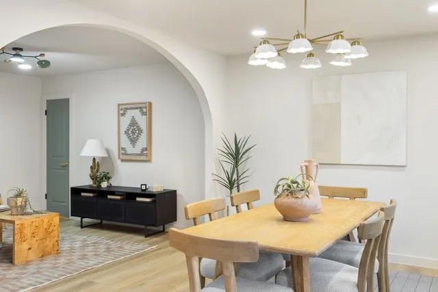 a view of a dining room with furniture and chandelier