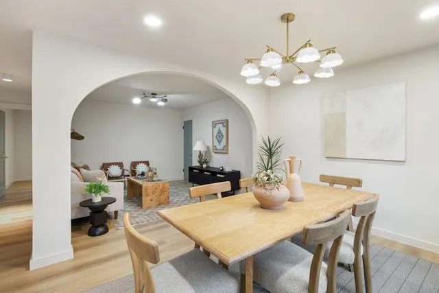 a view of a dining room with furniture and chandelier