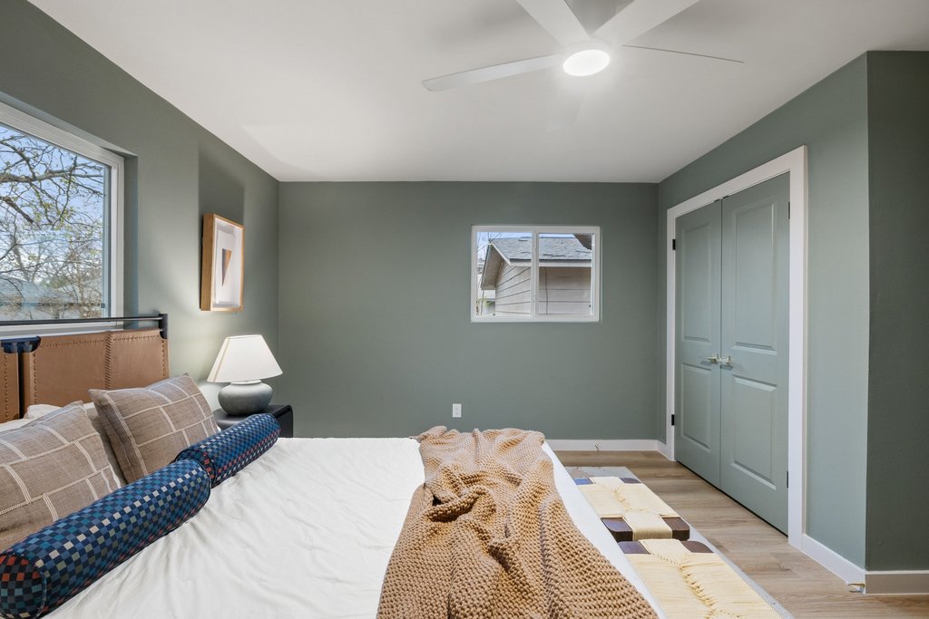 7614 Watson Street Austin, TX 78757 - Photo 20 of 31 a bedroom with a bed and wooden floor