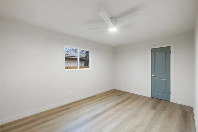 a view of a room with wooden floor and white walls