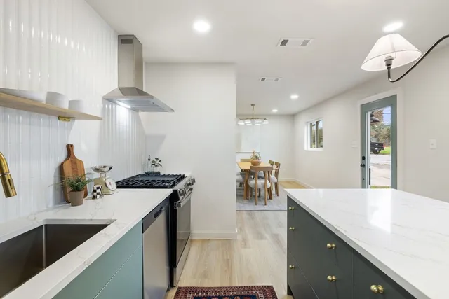 a kitchen with counter top space cabinets and appliances