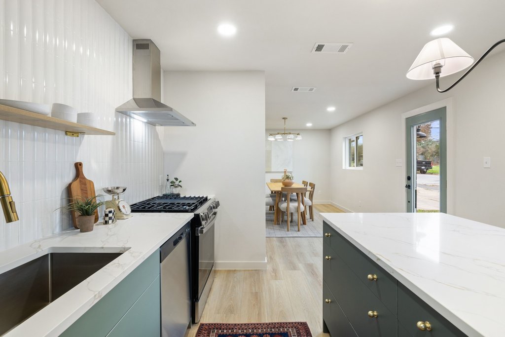 7614 Watson Street Austin, TX 78757 - Photo 9 of 31 a kitchen with counter top space cabinets and appliances