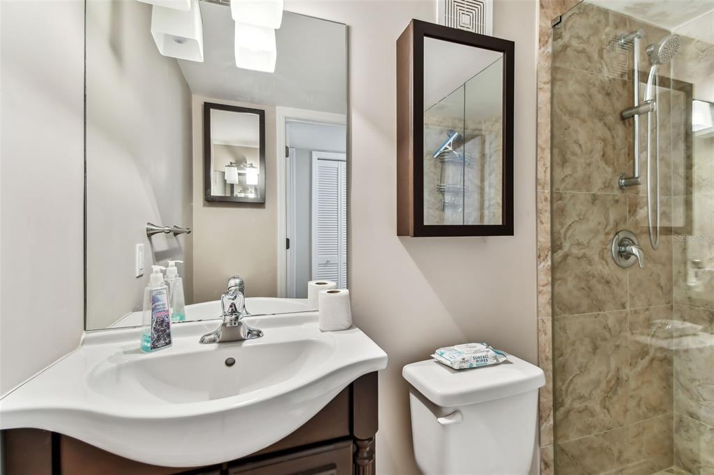 7701 Starkey Road, Unit 105 Seminole, FL 33777 - Photo 14 of 25 a bathroom with a sink a toilet and shower