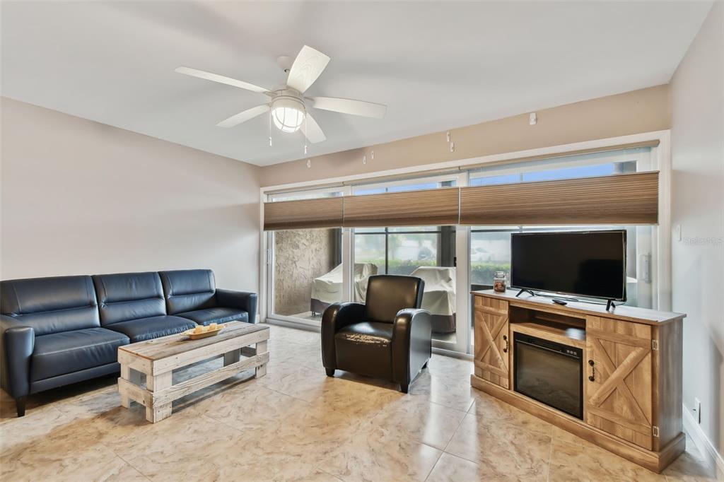 7701 Starkey Road, Unit 105 Seminole, FL 33777 - Photo 5 of 25 a living room with furniture and a flat screen tv