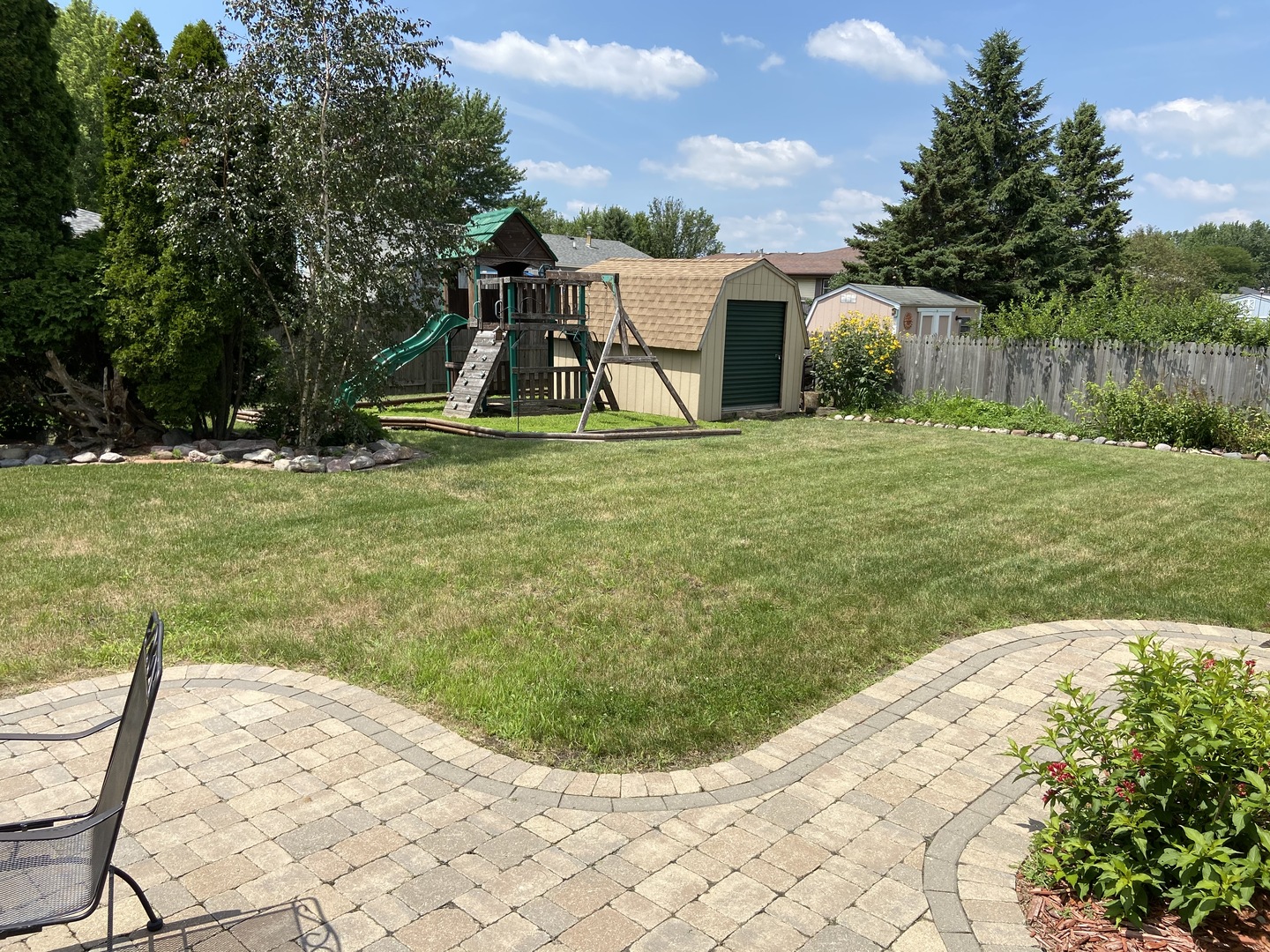 925 Knollside Road New Lenox, IL 60451 - Photo 26 of 32 a view of a garden with a slide