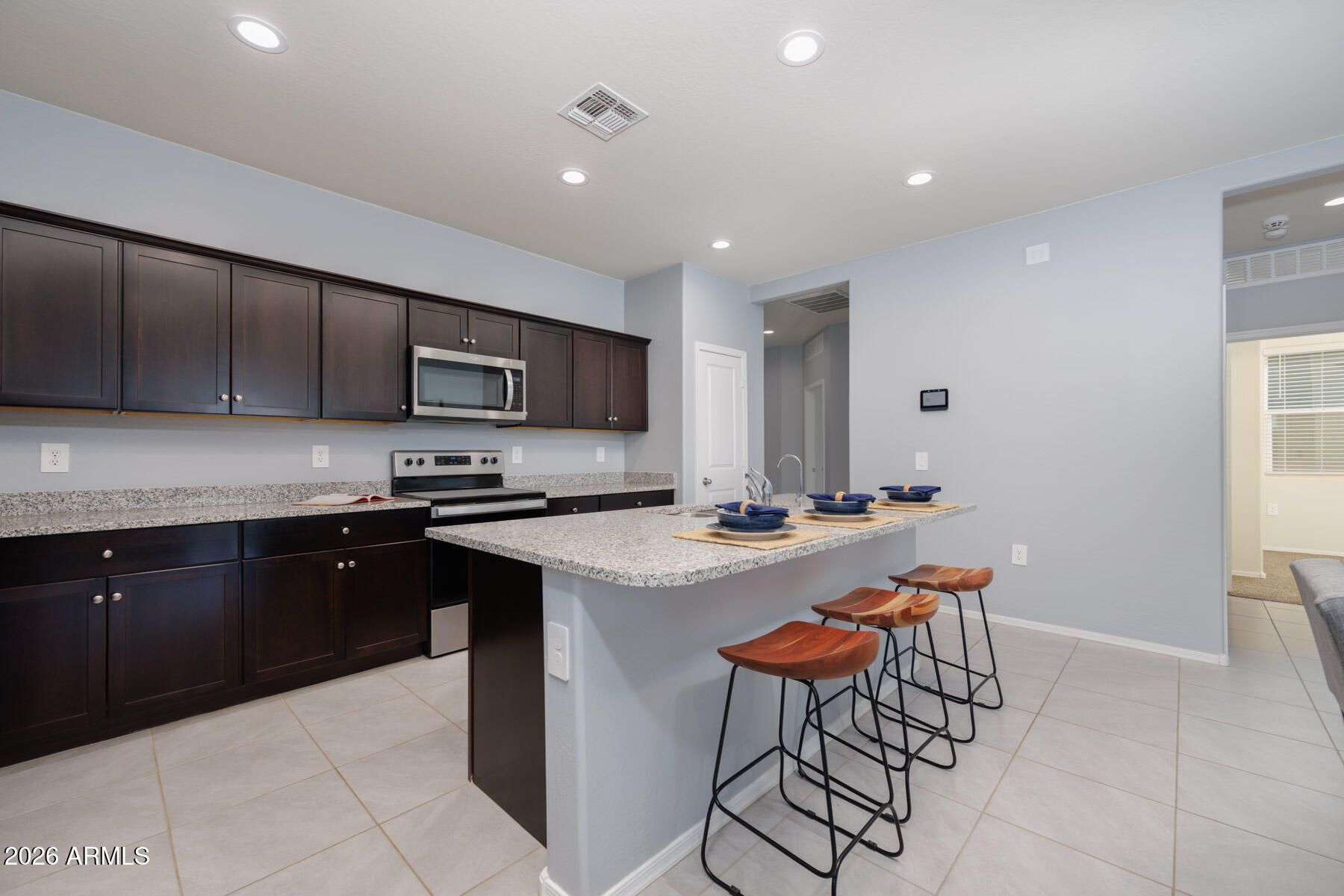 9381 Greenhouse Road Florence, AZ 85132 - Photo 10 of 35 a kitchen with a sink a microwave and cabinets