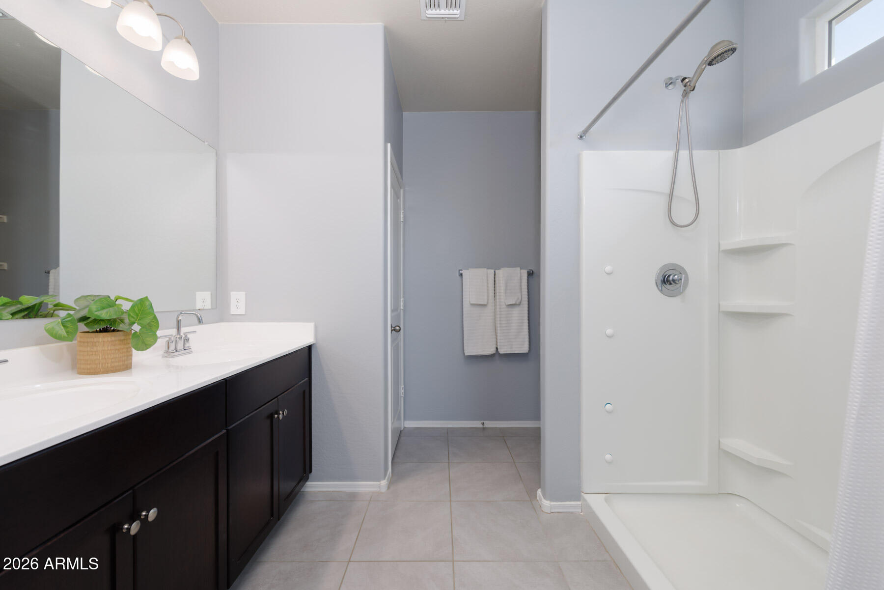 9381 Greenhouse Road Florence, AZ 85132 - Photo 14 of 35 a bathroom with a shower sink and mirror