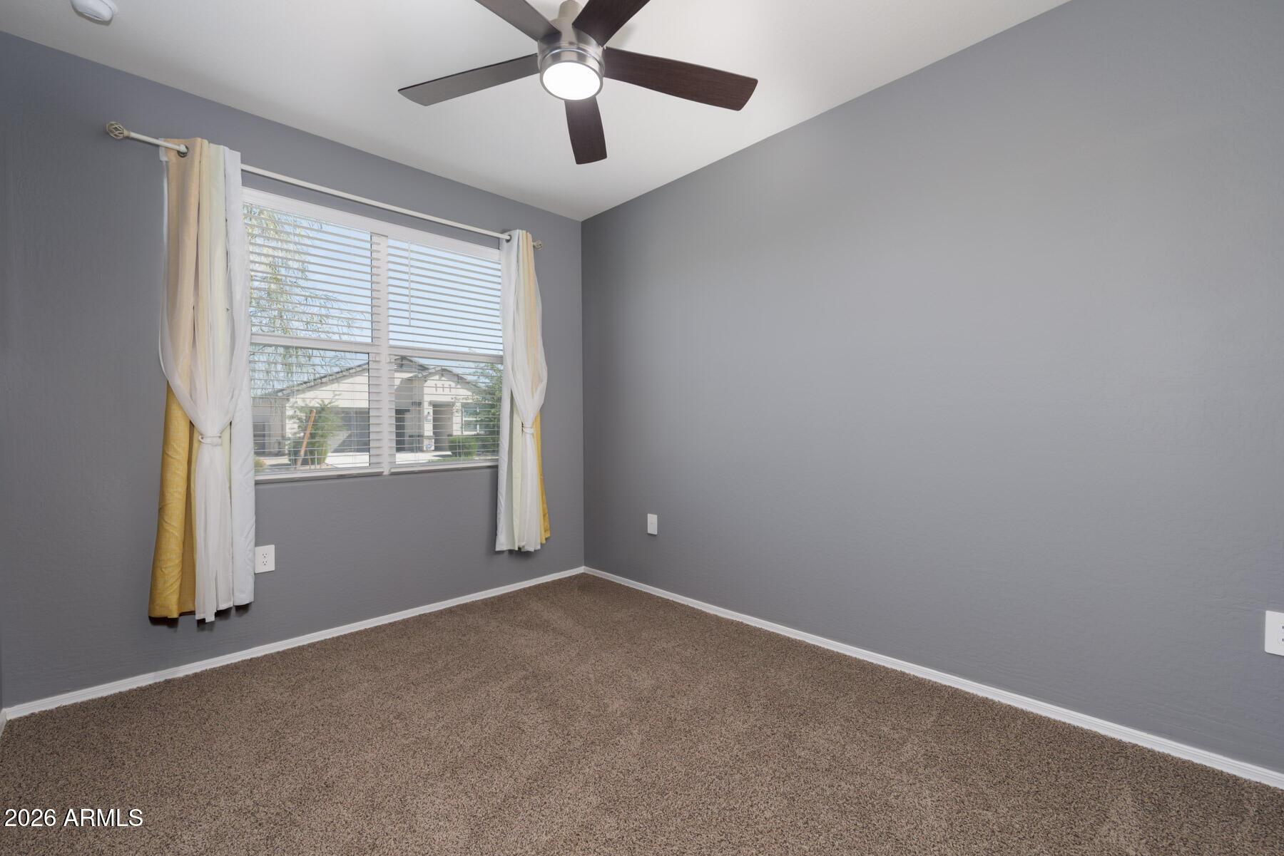 9381 Greenhouse Road Florence, AZ 85132 - Photo 17 of 35 an empty room with ceiling fan and windows