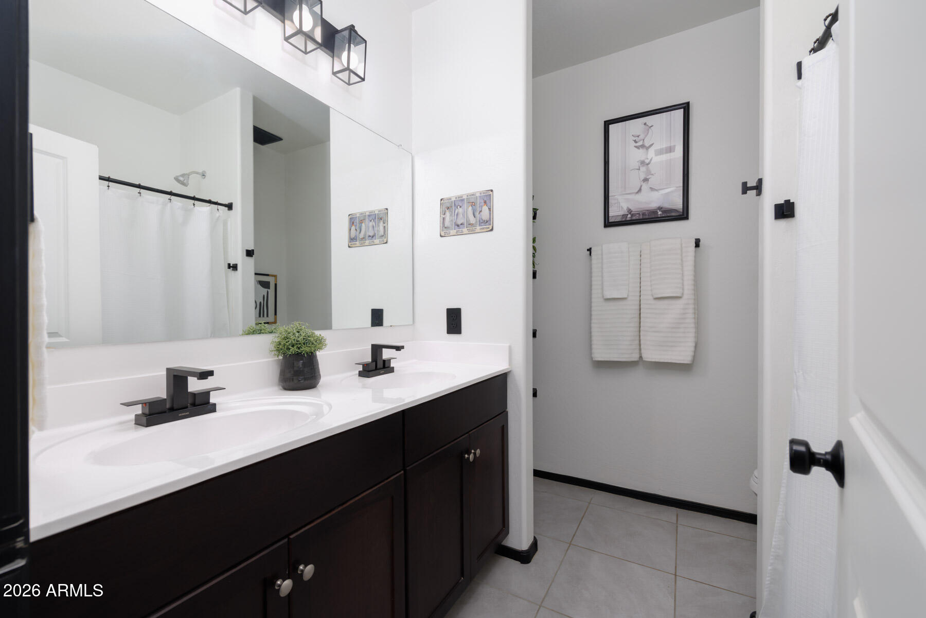 9381 Greenhouse Road Florence, AZ 85132 - Photo 18 of 35 a bathroom with a double vanity sink a mirror and shower