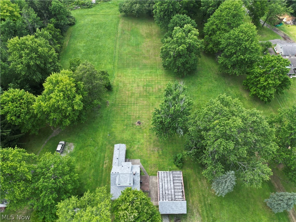 6324 Struthers Road Youngstown, OH 44514 - Photo 13 of 42 Expansive green lot featuring mature trees and a residential structure with a gray shingle roof