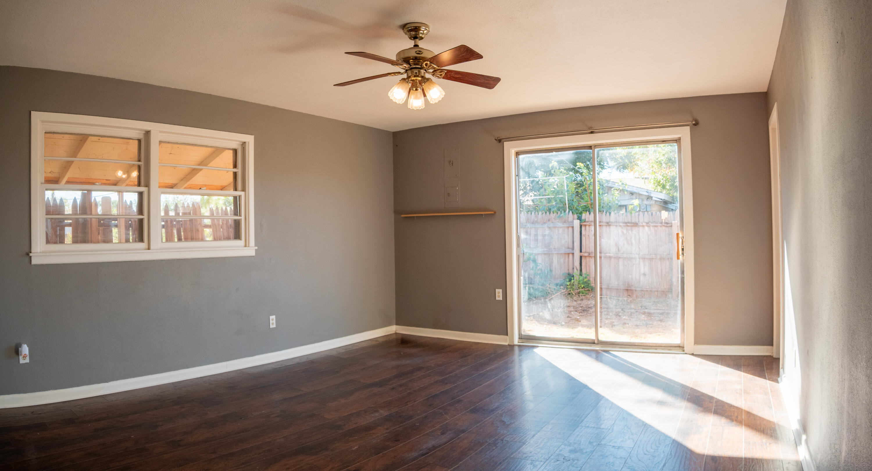 3415 48th Street Lubbock, TX 79413 - Photo 13 of 19 a view of an empty room with wooden floor and a window