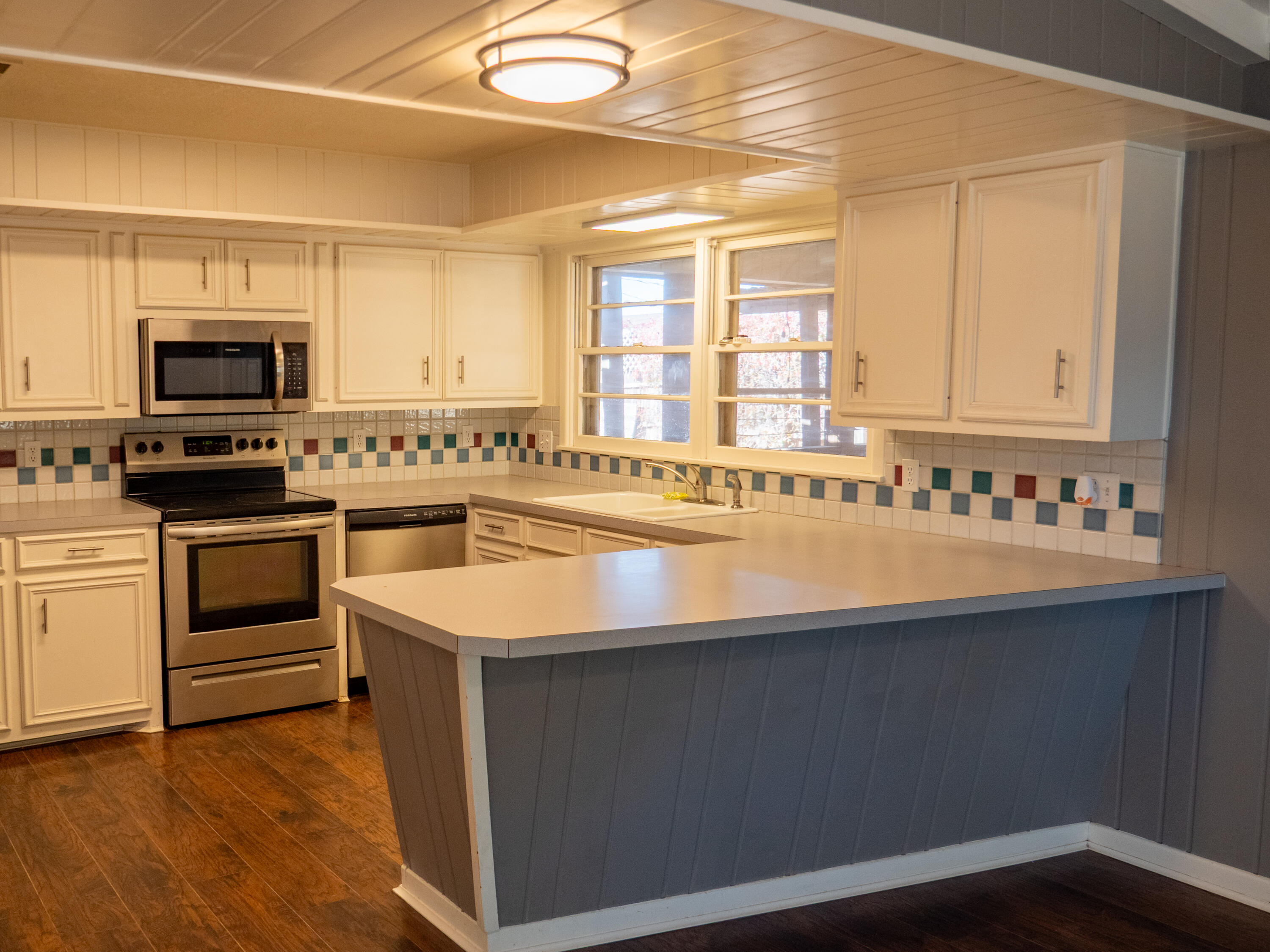 3415 48th Street Lubbock, TX 79413 - Photo 3 of 19 a kitchen with stainless steel appliances a sink stove and microwave