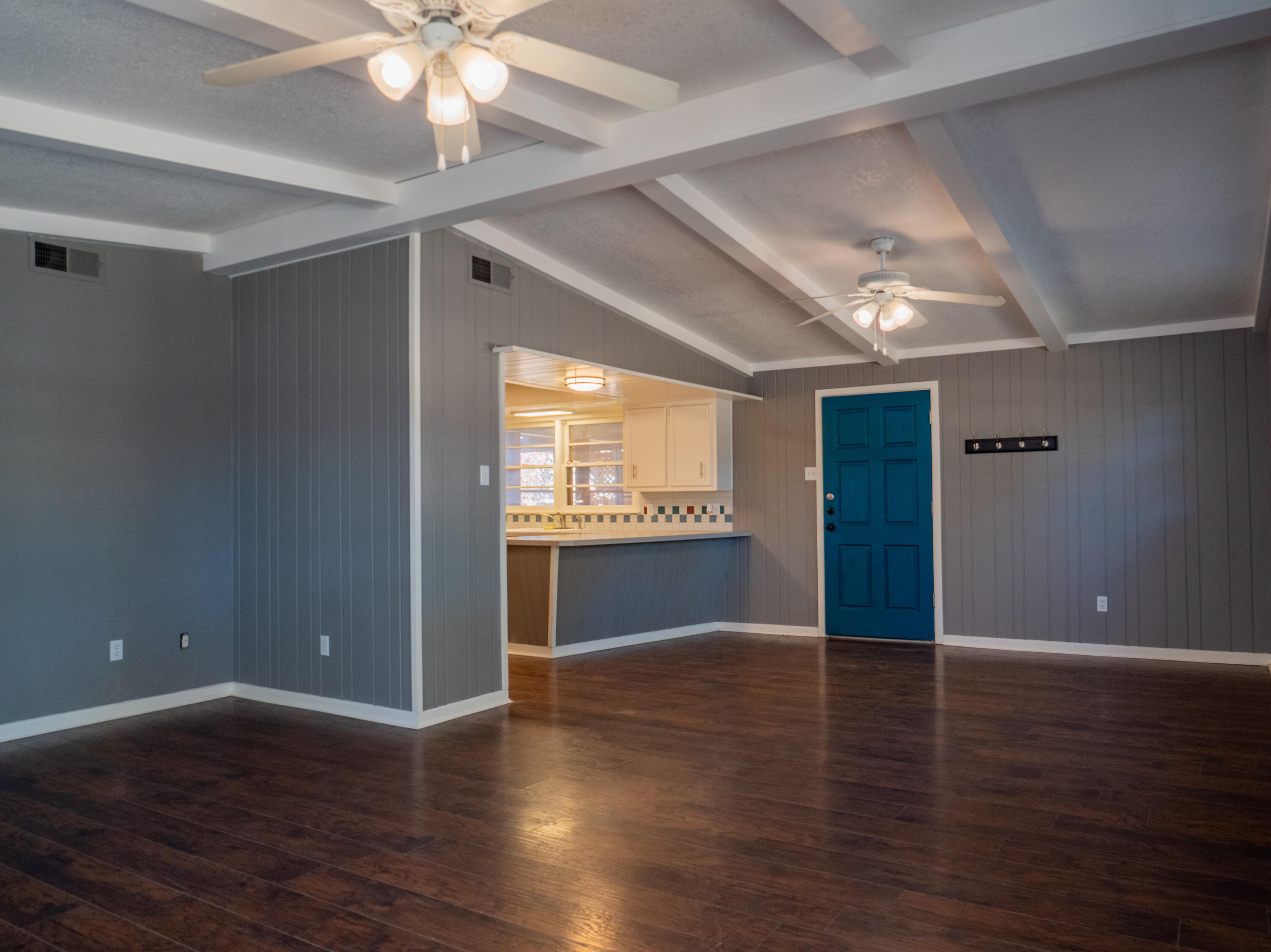 3415 48th Street Lubbock, TX 79413 - Photo 5 of 19 a view of an empty room with wooden floor and a window