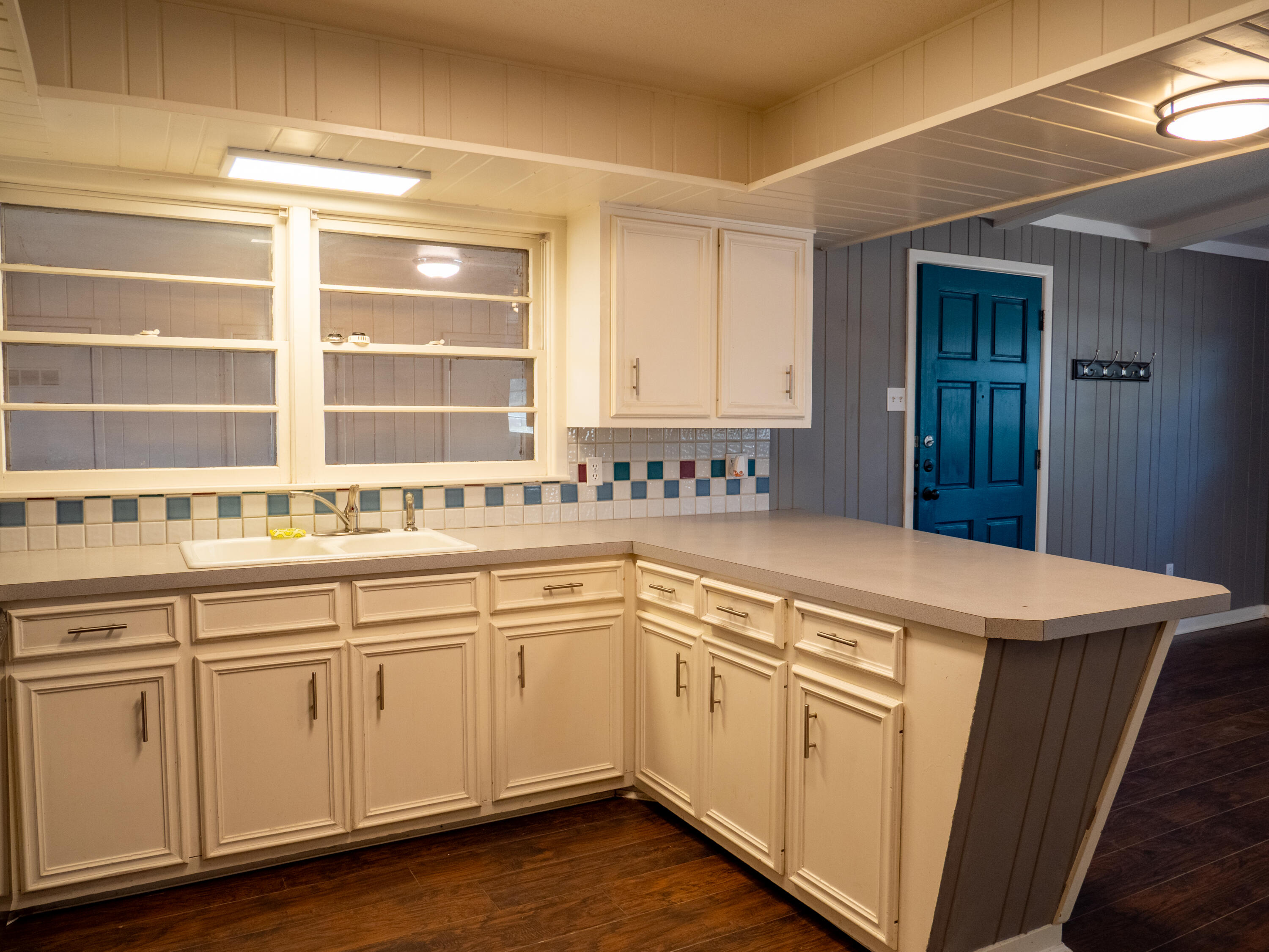 3415 48th Street Lubbock, TX 79413 - Photo 7 of 19 a kitchen with granite countertop white cabinets and white appliances