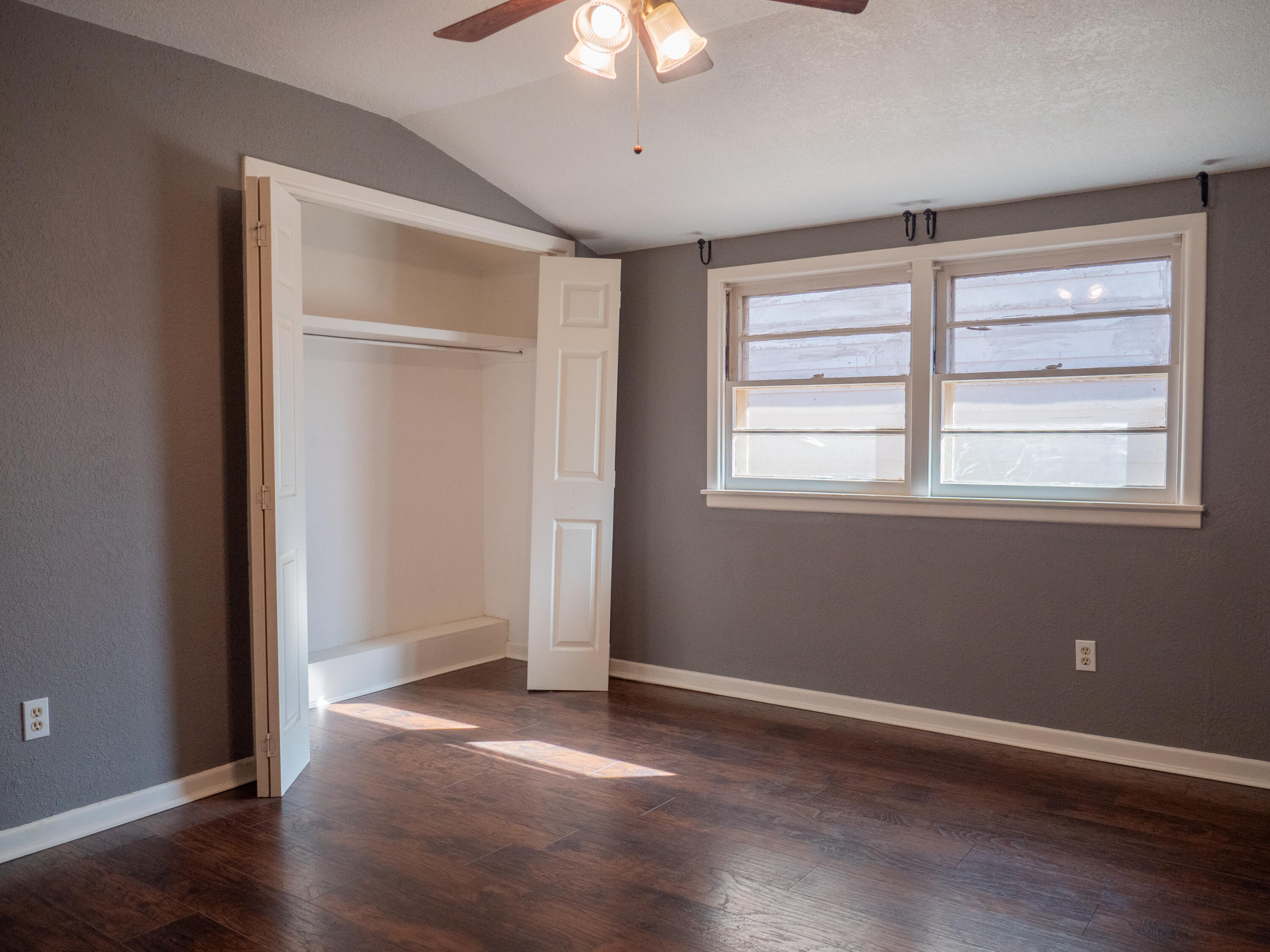 3415 48th Street Lubbock, TX 79413 - Photo 10 of 19 a view of an empty room with wooden floor and a window