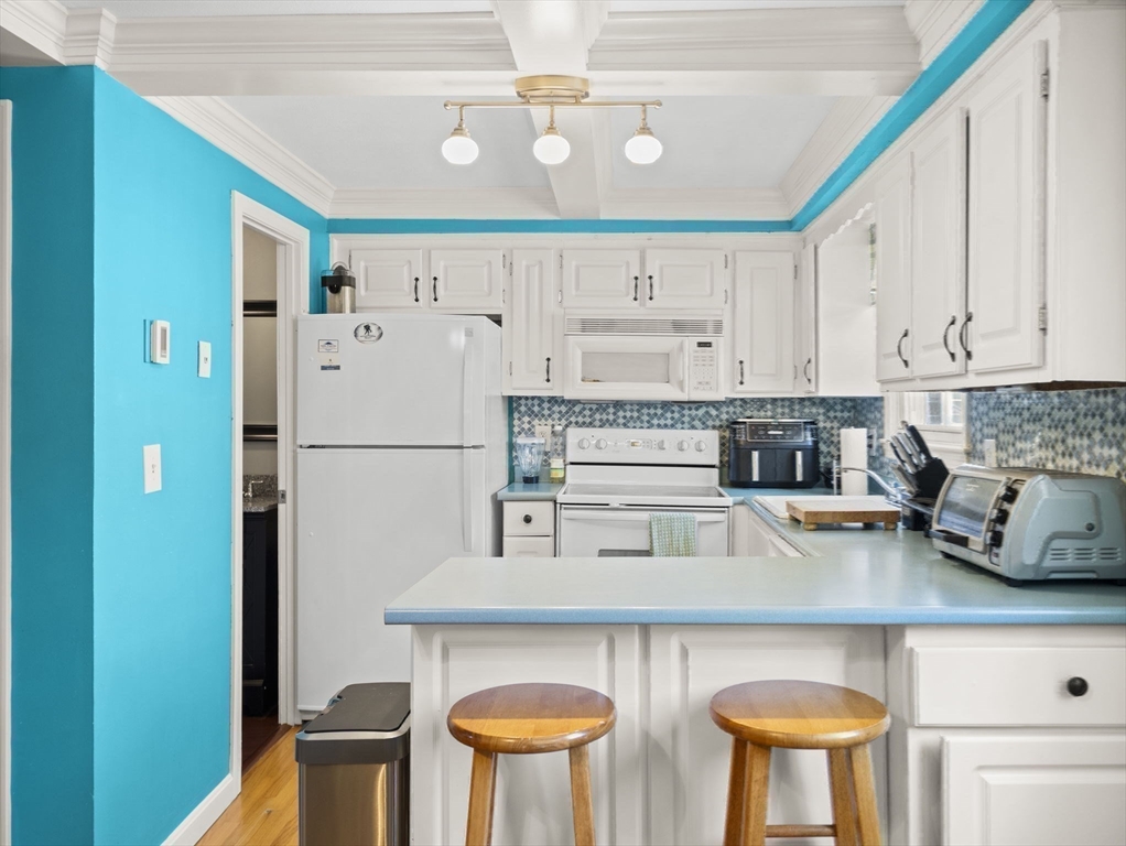 17 Cannongate Road, Unit 87 Tyngsborough, MA 01879 - Photo 11 of 39 a kitchen with stainless steel appliances granite countertop a refrigerator and a stove top oven