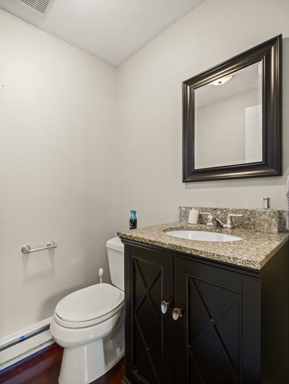 17 Cannongate Road, Unit 87 Tyngsborough, MA 01879 - Photo 15 of 39 a bathroom with a granite countertop toilet sink and mirror