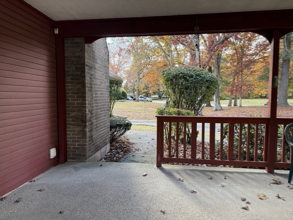 17 Cannongate Road, Unit 87 Tyngsborough, MA 01879 - Photo 32 of 39 a view of a porch with a floor to ceiling window next to a yard