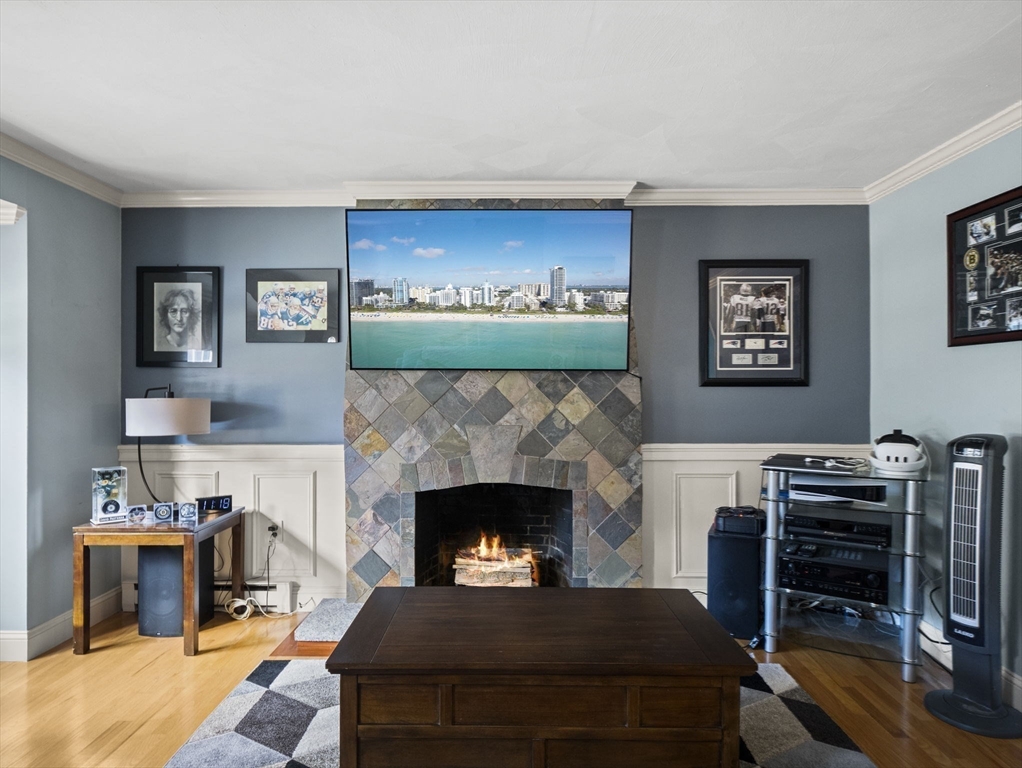 17 Cannongate Road, Unit 87 Tyngsborough, MA 01879 - Photo 5 of 39 a living room with furniture a flat screen tv and a fireplace