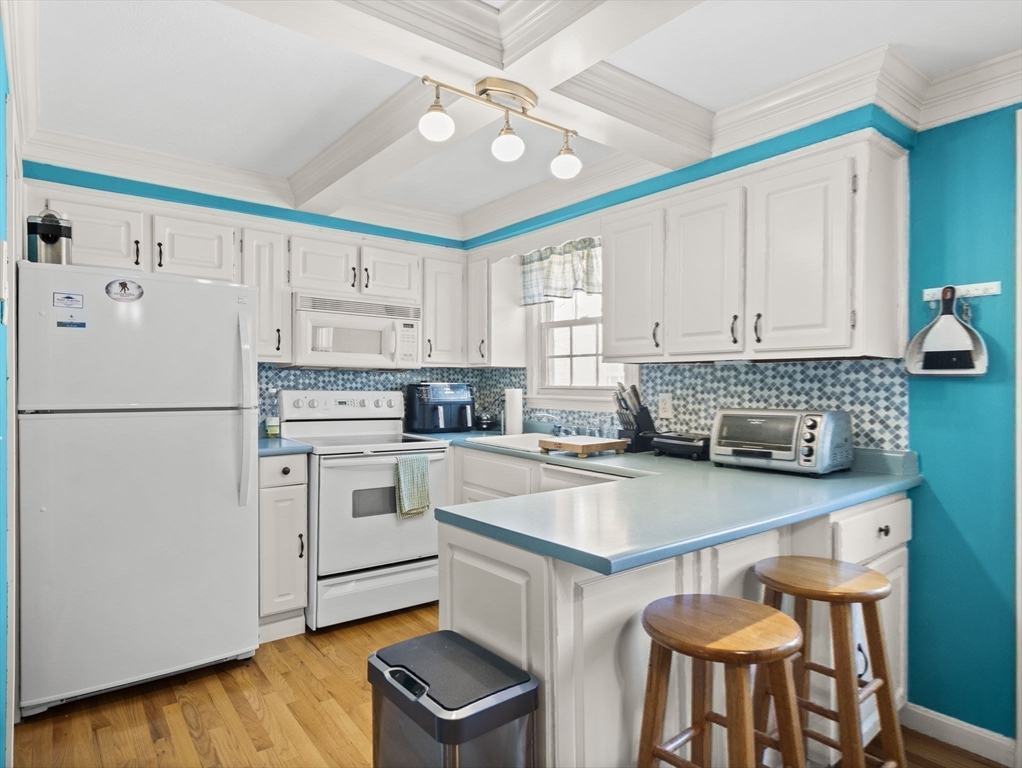 17 Cannongate Road, Unit 87 Tyngsborough, MA 01879 - Photo 9 of 39 a kitchen with white cabinets and white appliances