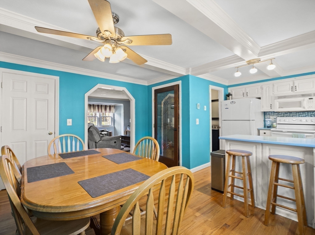 17 Cannongate Road, Unit 87 Tyngsborough, MA 01879 - Photo 10 of 39 a view of a dining room with furniture and a chandelier fan