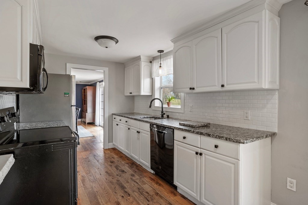 268 Forest Hills Road Springfield, MA 01128 - Photo 12 of 42 a kitchen with granite countertop white cabinets and stainless steel appliances