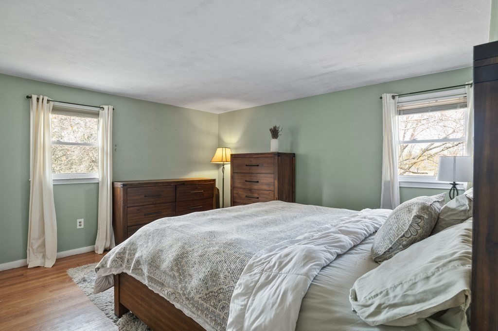 268 Forest Hills Road Springfield, MA 01128 - Photo 26 of 42 a bedroom with a large bed and wooden floor