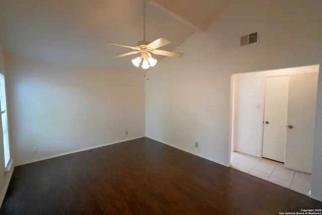 an empty room with a view of a house