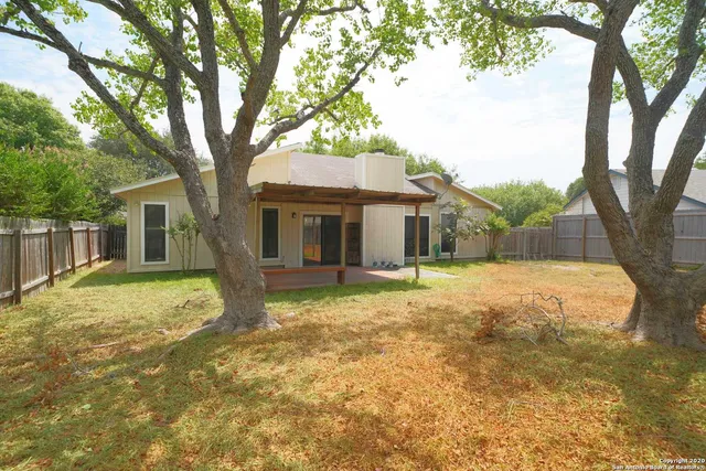 a house with trees in the background