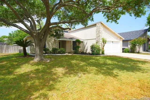 a view of house with backyard
