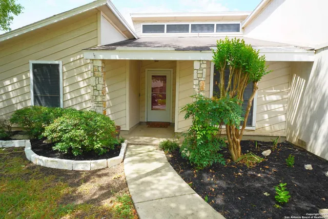 a view of a house with potted plants