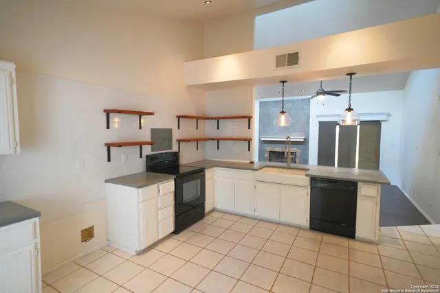 a kitchen with a sink and white cabinets