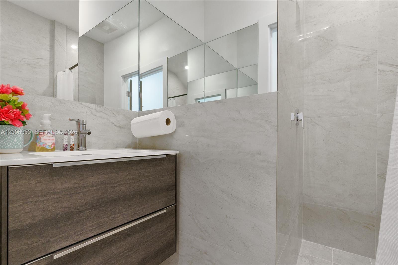 2889 Southwest 33rd Avenue, Unit 2889 Miami, FL 33133 - Photo 12 of 38 a bathroom with a sink and mirror