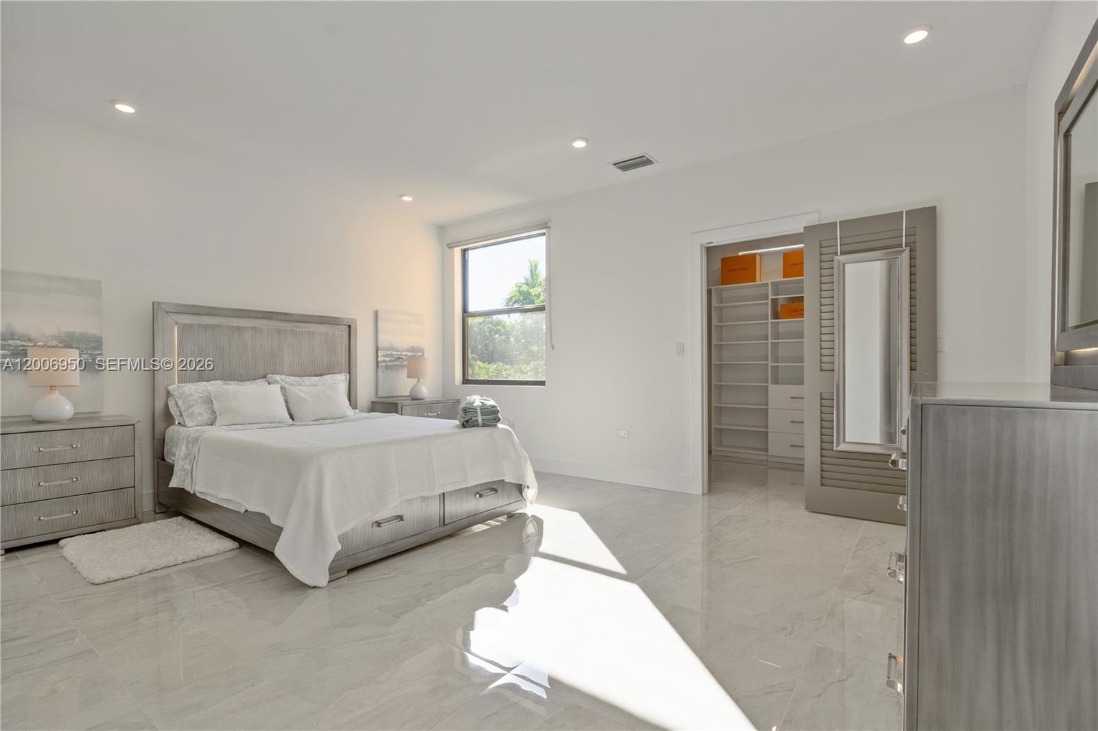 2889 Southwest 33rd Avenue, Unit 2889 Miami, FL 33133 - Photo 16 of 38 a spacious bedroom with a bed and a table